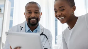 Médecin consultant le dossier médical numérique d'un patient pendant une consultation.
